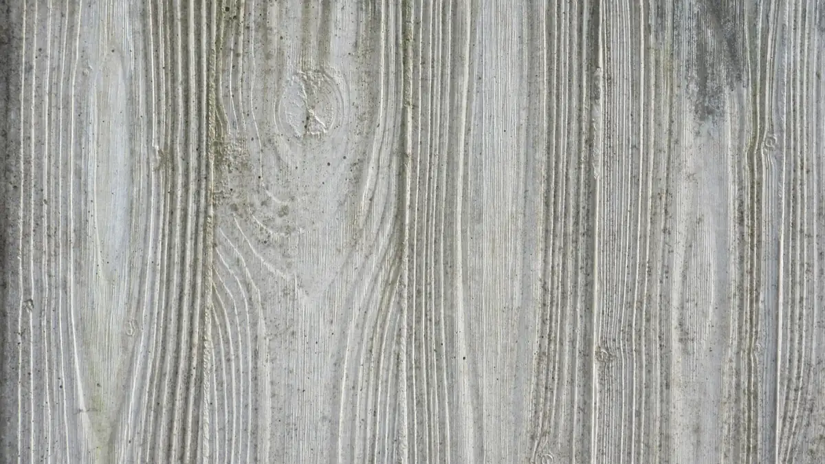 Board-formed decorative concrete showing a crisp wood-grain and knot imprint