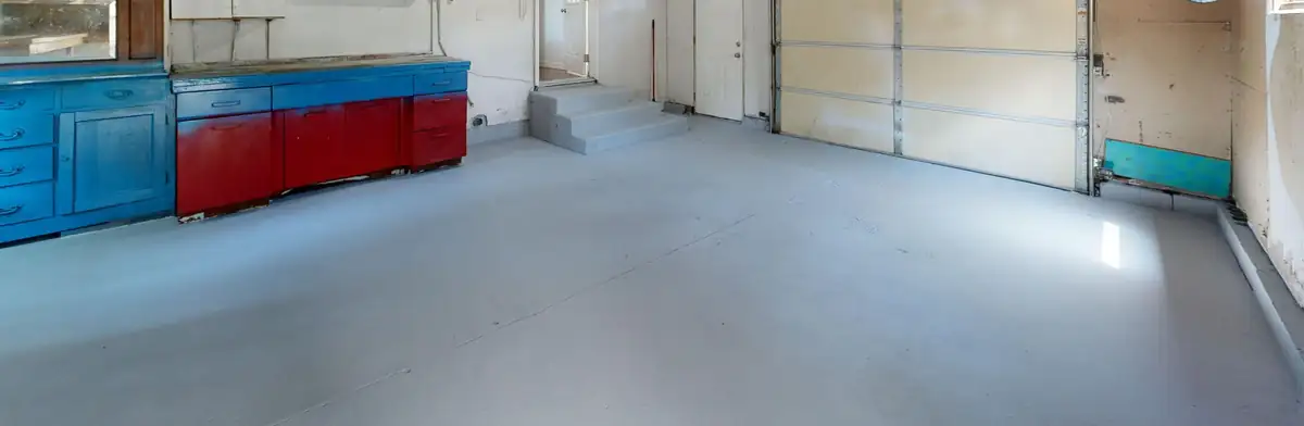 Single-car garage with a gray painted concrete floor, the kind of finish that peels before an epoxy system goes down